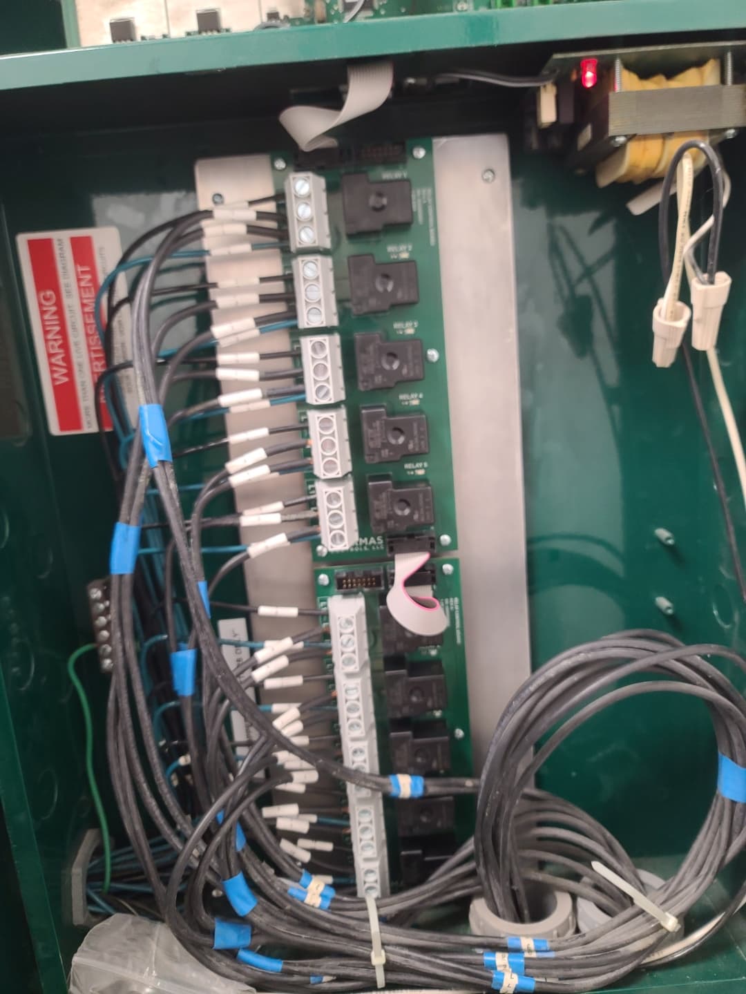 Integrated load control panel showing custom relay board wired and mounted on site